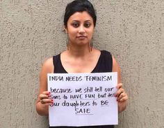 a woman holding a sign that says india needs feminist because we still sell our sons to have fun but their daughters to be safe