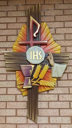 a cross with the word jesus on it and an image of a person holding a chalice