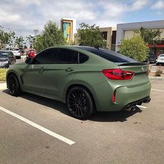 a green car parked in a parking lot