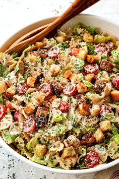 a white bowl filled with salad next to two cinnamon sticks