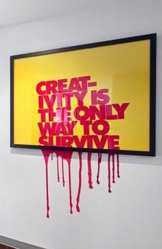 a painting hanging on the wall with red paint dripping down it's sides and words that read, great creativity is hy - only way to survive