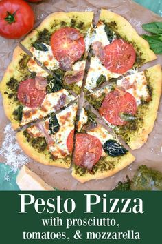 a pizza sitting on top of a wooden cutting board next to tomatoes and other vegetables