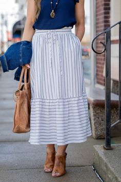 Striped Tiered Skirt For Summer, Chic Spring Skirt With Striped Hem, Chic Relaxed Skirt With Striped Hem, Chic Skirt With Striped Hem And Relaxed Fit, Summer Striped Flowy Skirt, Spring Striped Tiered Skirt, Ruffle Hem Midi Skirt For Day Out, Spring Relaxed Skirt With Striped Hem, Relaxed Skirt With Striped Hem For Spring