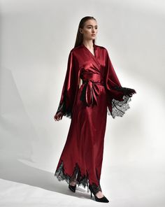 Irresistible in its classic cut, the silk kimono robe with lace embellishments exudes passion. Crafted from silk and satin blend, it features a dramatic, long sweeping hem and draped sleeves, creating a captivating silhouette reminiscent of old Hollywood glamour. The broad obi-style sash draws the waist for a polished profile, making it the epitome of sophistication and a luxurious start to every morning. ✓ garment length - 147 cm/58'' ✓ wrap over style ✓ two sets of inside ties ✓ wide obi-tie i Luxury Gown With Satin Finish, Luxury Wedding Gown With Satin Finish, Luxury Silk Gown With Satin Finish, Luxury Satin Wedding Night Dress, Elegant Wedding Gown With Kimono Sleeves, Long Satin Evening Gown, Luxury Satin Gown, Luxury Silk Kimono For Evening, Luxury Long Sleeve Silk Gown