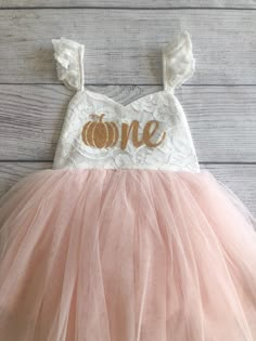 "♥ Product Information 100% Cotton in bodice and lining 100 % polyester tulle skirt Do not bleach Color is an Off White for the top and light pink for the tutu. Pumpkin age one is a gold color on the dress. Toddler tutu dress 's elastic back has a small loop to tie the strap crossover, adjust the length accordingly for a comfortable fit Beautiful baby dress has 4 layers exquisite fine tulle on the skirt with cotton lining to protect toddler girls gentle skin; Double layer front bodice with sweat Cute Peach Party Dress, Summer Princess Dress With Lace Bodice, Cream Sleeveless Princess Tutu Dress, Summer Tulle Princess Dress For Birthday, Spring Pink Tutu Dress With Lace Bodice, Pink Tutu Dress With Lace Bodice For Dress-up, Cream Princess Dress With Tulle Skirt For Party, Summer Cream Tulle Princess Dress, Spring Princess Cream Tutu Dress