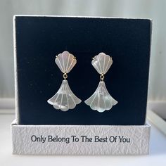 These mermaid earrings are pure mother of pearl and are hand carved into a fan shape. Pearls have an incredible luster, giving off a colorful and subtle glow when exposed to light. The earring posts are made of gold-plated brass. The earrings are designed with small scalloped mother-of-pearl on the top, which has a 3D surface effect, and a double-sided flat design hanging on the bottom. Gift Shell-shaped Mother Of Pearl Earrings, Pearl White Drop Clip-on Earrings As Gift, Pearl White Drop Clip-on Earrings For Gift, Party Mother Of Pearl Dangle Earrings, Mother Of Pearl Dangle Earrings For Party, Formal Pearl White Mother Of Pearl Earrings, Bridal Mother Of Pearl Earrings For Wedding, Party Pearl Drop Earrings In Mother Of Pearl, Pearl White Mother Of Pearl Dangle Earrings