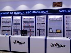 a display case with many items on it in a room that is well lit and has the words welcome to daha technology