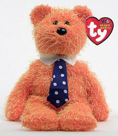 an orange teddy bear with a tie on