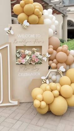 a welcome sign surrounded by balloons and flowers