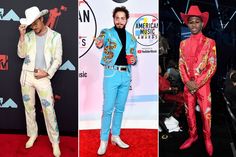 three men in colorful outfits at the american music awards, one wearing a cowboy hat