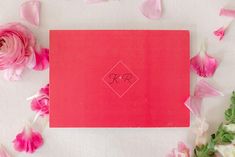 a red envelope with the initials r and c on it surrounded by pink flowers