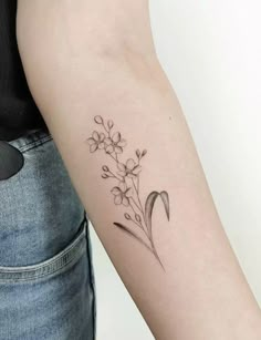 a woman's arm with a flower tattoo on the left side of her arm