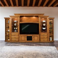 a large entertainment center with wooden shelves and drawers