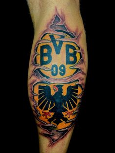 a man's leg with an eagle and the number 999 tattooed on it