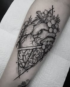 a black and white photo of a heart with flowers on it's side arm