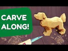 a wooden toy dog next to a green sign with the words carved along it's side