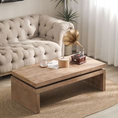 a living room with a couch, coffee table and rugs on the floor in front of it