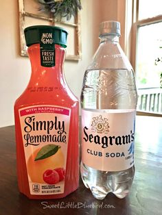 two bottles of seagram's and a bottle of lemonade sit on a table