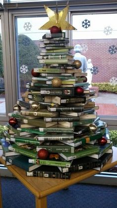 a christmas tree made out of books on a table