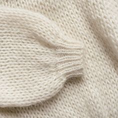 the texture of a white knitted sweater