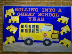 a bulletin board with yellow school buses and blocks on the front, reading rolling into a great school year