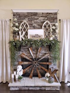 a living room with a stone fireplace and white curtains on the window sill, decorated with greenery