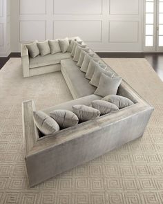 a large sectional couch sitting on top of a rug