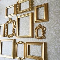 there are many gold frames on the wall