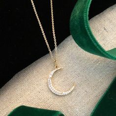 Our stunning crescent moon charm is a great addition to any layer up of symbols and talismans. The moon can represent changes through time as the moon goes through phases and is also a symbol of the Goddess Diana who was patron goddess of the moon. Sterling silver plated in 14K gold with cubic zirconia stones. 16" chain with extension. All orders over $50 ship for free within the USA. All orders usually ship within 24 hours from the USA. Elegant Moon Phase Necklace In Moon Shape, Spiritual Crescent Moon Phase Necklaces, Spiritual Crescent Moon Phase Necklace, Symbolic Moon Charm Round Pendant Necklace, Symbolic Moon Charm Pendant Jewelry, Spiritual Round Moon Charm Necklace, Spiritual Round Moon Phase Charm Necklace, Elegant Half Moon Charm Jewelry, Celestial Crescent Moon Phase Necklace