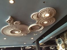 the ceiling is decorated with decorative objects and lighting fixtures, including chandelier lights