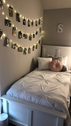 a white bed topped with lots of pictures and lights