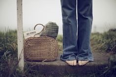 a person standing next to a basket on the ground