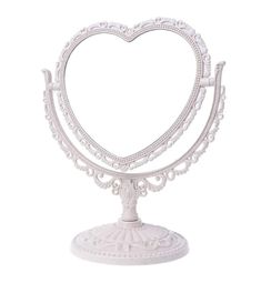 a white heart shaped cake stand on a white background