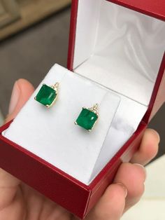 Elegance defined! These emerald and diamond earrings are fashioned in solid 14k yellow gold. These studs feature natural Asscher cut emeralds accented with natural white diamonds. The emeralds have a combined 2.81 total carat weight and a dark green hue that contrasts with the flashing fire of the diamonds. The brilliant round diamonds have a combined 11 points. Perfect for every day! Setting Style: Emerald & Diamond Studs Setting Weight: 2.0 grams Setting Material: 14K Yellow Gold Main Ston Gia Certified Green Diamond Earrings For Anniversary, Formal Yellow Gold Diamond And Emerald Earrings, Gold Emerald Diamond Earrings, Emerald Earrings With Diamond Accents For Gifts, Elegant Green Diamond Earrings In 14k Gold, Emerald Yellow Gold Diamond Earrings Fine Jewelry, Emerald Diamond Earrings For Anniversary, May Birthstone, Fine Jewelry Green Diamond Earrings As Gift, Emerald Yellow Gold Diamond Earrings