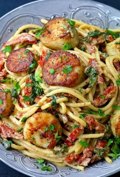 pasta with scallops and tomatoes in a bowl