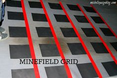 a man standing on top of a metal floor next to red and black lines with the words minefield grid