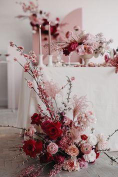 a table with flowers and candles on it