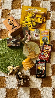 various items are arranged on a checkered tablecloth with an area rug in the foreground