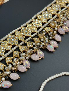 This lightweight and dainty set in thapa kundan or multani work is made of high quality gold plating and has gorgeous pink crystal drops that have an ombre finish. The colors are super unique and pastel so that they can go with any outfit whether its a saree or lehenga! and can be worn separately for a simple look. This lightweight and elegant necklace is perfect for any bridesmaid, bride, sangeet or any occasion or event as a gift for any occasion as any one who loves jewelry will love this sta Pink Kundan Sets With Cutdana, Pink Kundan Traditional Party Wear, Pink Kundan Traditional Wear For Parties, Elegant Pink Kundan Jewelry Sets, Elegant Pink Kundan Sets, Elegant Kundan Dupatta For Celebration, Pink Kundan Set For Party, Pink Kundan Party Sets, Pink Tilla Dupatta For Diwali