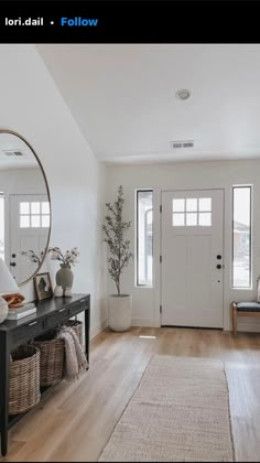 a living room filled with furniture and a large mirror