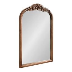 an ornate wooden mirror on a white background