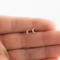 Such a cute, and dainty pair of earrings! They're perfect alone or stacked. They're a tiny pair that are perfect for second piercings, cartilage piercings, or for a minimalist touch. ✤✤ Details ✤✤ ★ Made of 925 Sterling Silver ☾ We use a THICK plating of 14k Gold or Rhodium for a piece that is sure to last you years to come ★ Sold as a PAIR ☾ Nickel-free & Hypoallergenic ★ Measures 5 mm x 4 mm ☾ We use the highest grade of cubic zirconia for an authentic diamond look Comes in a cute gift box Tiny Studs Earrings, Second Stud Earrings Indian, Dainty Moon Shaped Hypoallergenic Earrings, Dainty Moon-shaped Hypoallergenic Earrings, Dainty Hypoallergenic Moon-shaped Earrings, Dainty Hypoallergenic Moon Earrings, Dainty Half Moon Charm Earrings, Dainty Half Moon Earrings With Moon Charm, Dainty Moon Phase Earrings