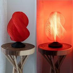 two lamps sitting next to each other on wooden tables