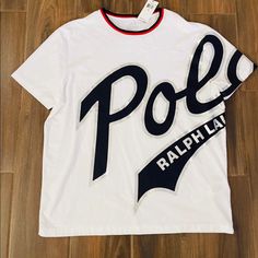 It’s A White T-Shirt With Polo Logo On It By Polo Ralph Lauren . It’s Brand New With Tags . Never Worn As Size Is Not Fit Cotton Logo Short Sleeve Tops, Short Sleeve Cotton Top With Logo, Cotton Logo Top With Short Sleeves, Sporty Cotton Tops With Logo, Casual Short Sleeve Shirt With Logo, White Cotton Top With Logo, White Crew Neck Top With Logo, Casual Short Sleeve Logo Top, White Short Sleeve Top With Logo