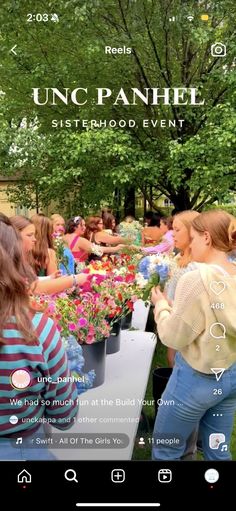 an image of a group of people in the park with flowers and plants on display