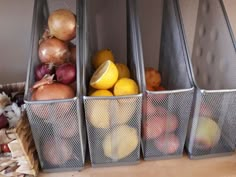 three bins filled with fruits and vegetables on top of a counter next to a basket