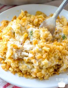 a white plate topped with food and a spoon