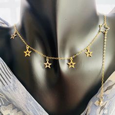 Stars charm choker, long dangle gold necklace, 14K gold filled, Handmade in USA, Gift for her Original well-design makes unique and elegant look. Simple stylish with high quality materials to wear everywhere. Perfect as gift for her. Both raw materials and final products are made in USA. Designed and handmade by Rachel L. About 14k Gold filled metal: 14k is bonded to other metals (sterling silver, copper) and is over 100 times thicker than high quality plated gold. Durable & tarnish resistant, these rings are suitable for daily wear. Filled gold necklaces are beautiful, affordable alternatives to solid gold, and can be worn by people with sensitive skin. Dainty Star-shaped 14k Gold-filled Necklace, Dainty 14k Gold-filled Star Necklace, Dainty 14k Gold Filled Star Necklace, Gold Star Charm Choker, Gold Star-shaped Jewelry With Adjustable Chain, Gold Plated Dainty Necklace With Star Charm, Celestial Gold Choker Necklace, Celestial Dangle Necklace With Star Charm, Dainty 14k Gold Filled Star Charm Necklaces