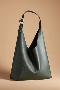 This oversized tote is your new BFF. Tied with two playful knots, this just-right sized, slouchy silhouette is designed to hold all your essentials (and more!) effortlessly – and with a touch of oh-so-fashionable flair. | The Love Knot Slouchy Bag: Buckle Edition by Anthropologie in Green, Women's, Polyurethane Slouchy Leather Tote, Winter Purses, Leather Hobo Bags, Blue Leather Bag, 2024 Wishlist, Everyday Handbag, Fall Handbags