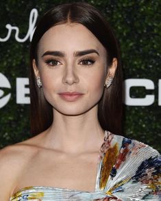 an image of a woman with long hair wearing a colorful dress and diamond earring